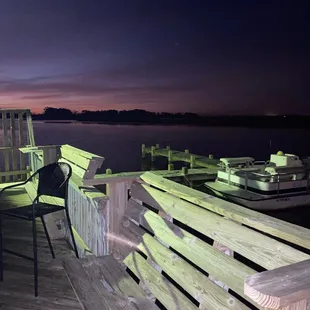 a dock with chairs and a table