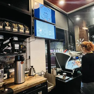 a woman working in a coffee shop
