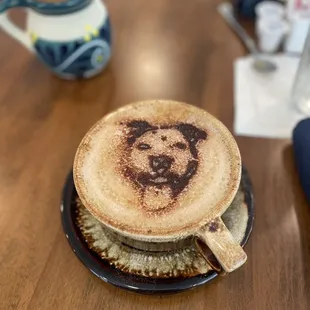 a cup of coffee with a picture of a dog on it