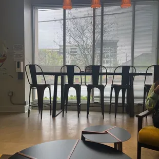 a view of a living room with a dining table and chairs