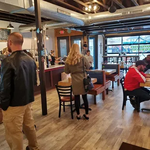 people sitting at tables in a coffee shop