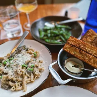 Mushroom pasta was wildly undercooked, could taste the raw flavor. Charred snap peas unremarkable. Hand-Cut BDT Triple Fries.