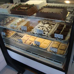 Display case on the left with cakes, brownies, &amp; bars.