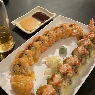 a plate of sushi and a glass of beer