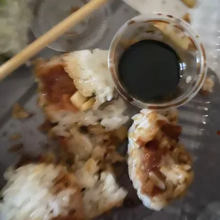 a plate of sushi and chopsticks