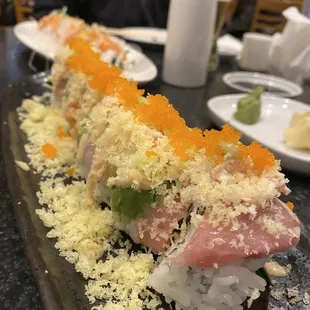 a sushi roll on a black plate