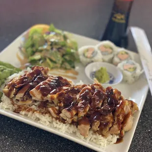a plate of sushi and a salad