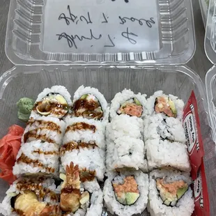 a plastic container of sushi