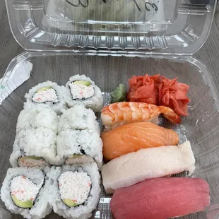 a plastic container of sushi