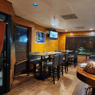 a dining area with tables and chairs