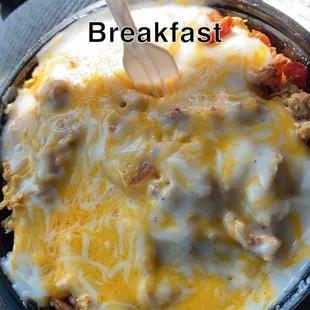 Breakfast bowl, has ham bacon sausage, with country potatoes, egg and white gravy