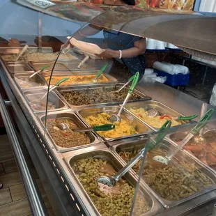 a woman serving food at a buffet