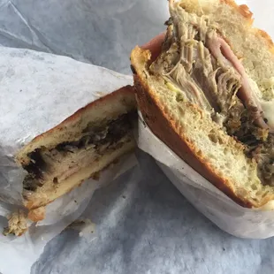 Delicious Cuban panini stuffed with tender meat, pickles, Swiss cheese on fresh toasted bread.