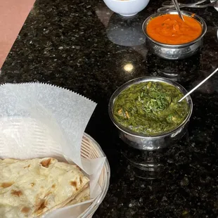 a table with bowls of food and bowls of dips