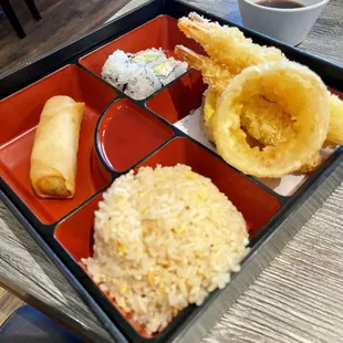 Tempura Shrimp Bento box 3 Shrimp, Sweet Potato, Zucchini, Onion Ring, California Roll, White Rice, Egg Roll, and Choice of Soup or Salad.