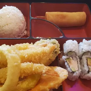 Lunch bento with shrimp &amp; veggie tempura, Cali roll, veggie egg roll, and rice.