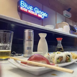 a plate of sushi and chopsticks