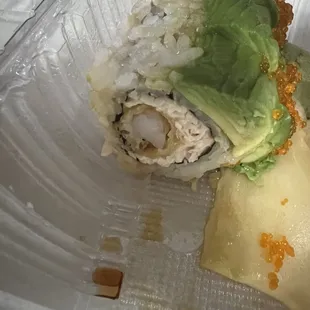 a sushi roll with lettuce and cheese