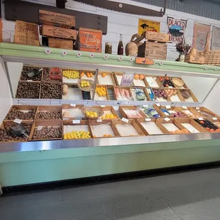 a woman standing in front of a display of produce