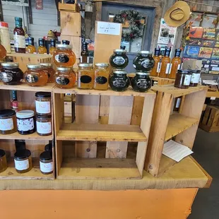 a man looking at jars of honey