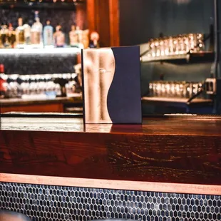 a bar with stools and a menu