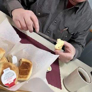 a man cutting a sandwich with a knife