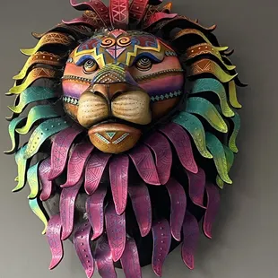a colorful lion head on a wall