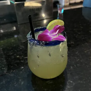 a margarita with a flower garnish