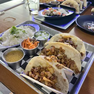 Al pastor tacos with cilantro rice- background are the street tacos.