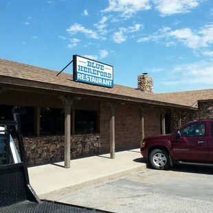 a red truck parked in front of a building