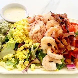 We serve lunch Wednesday through Sunday 11am-3pm. This beauty is our 1/2 size Seafood Cobb Salad with house made bleu cheese dressing.