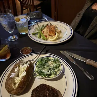 A nice filet with baked potato and creamed spinach. Salmon with asparagus