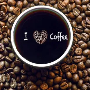 a cup of coffee surrounded by coffee beans