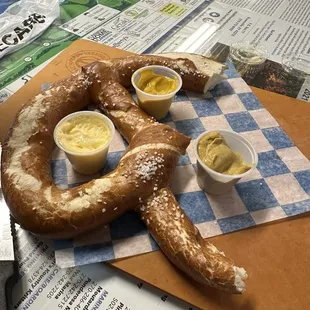 Pretzel with butter, mustard, and brown mustard
