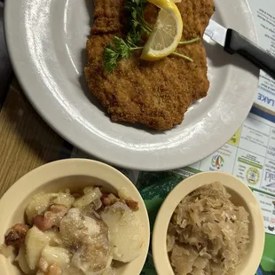 Schnitzel, German potato salad, and sauerkraut