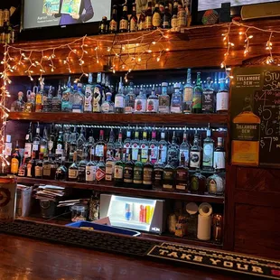 a bar with many bottles of alcohol