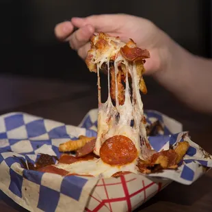 a person eating a slice of pizza