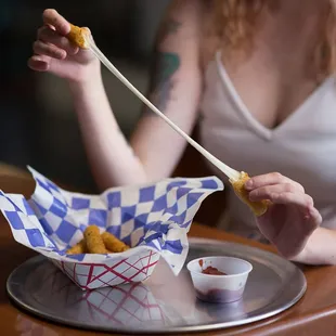 a woman eating food with chopsticks