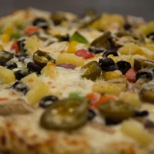 a pizza with olives and peppers