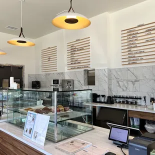 a bakery counter with a glass case