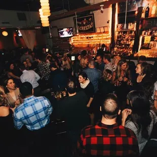 a crowd of people at a bar