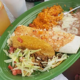 Beef taco and shredded chicken burrito with rice and beans.