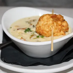 The Clam Chowder is made with clams, bacon and comes with a Sea Clam Fritter on top.