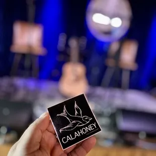 a person holding a sticker