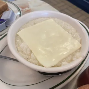 a bowl of rice with cheese on top