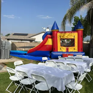 Blue Red Yellow Waterslide Combo Jumper Bounce House Inflatable #C002 13' x 30' Angled View 2 White Tables and Chairs with Tables Cloths