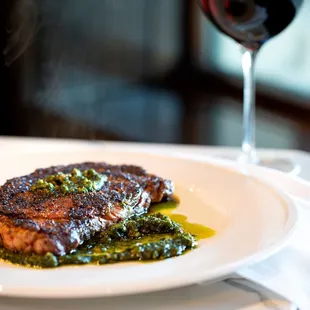 a steak and a glass of wine