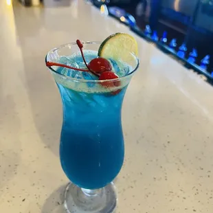 a close up of a blue cocktail