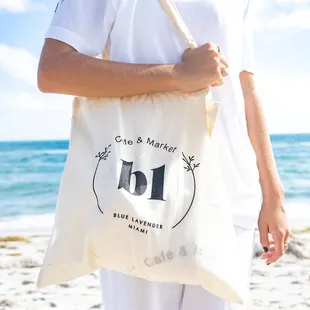 a woman carrying a tote bag on the beach