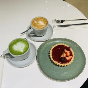 a cup of cappuccino and a strawberry tart